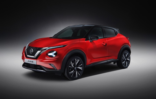 Красный автомобиль Nissan Juke 2019 года на сером фоне