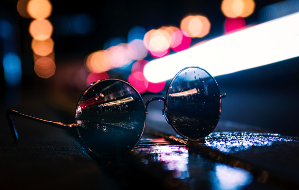 Солнцезащитные очки лежат на мокром асфальте