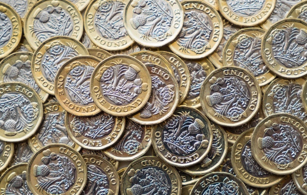 Lots of pound sterling coins close up