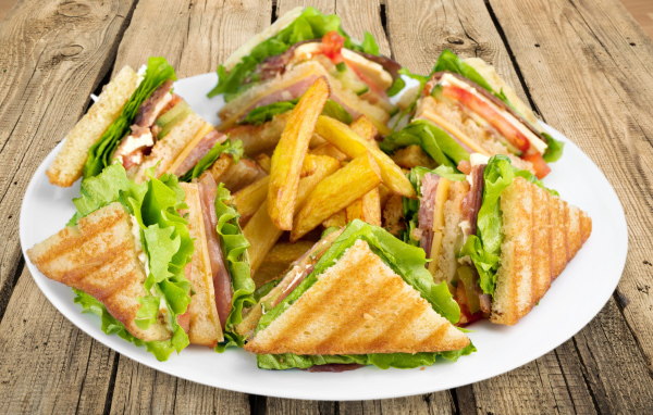 Ham sandwiches on a plate of french fries