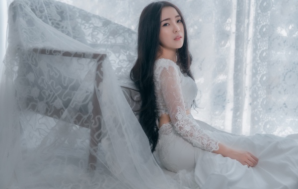 Красивая девушка азиатка в белом свадебном платье 