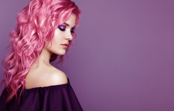 Красивая девушка с розовыми волосами на сиреневом фоне