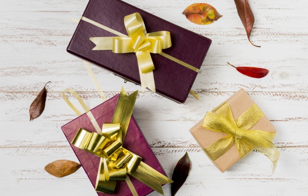 Три подарочные коробки с бантами на столе