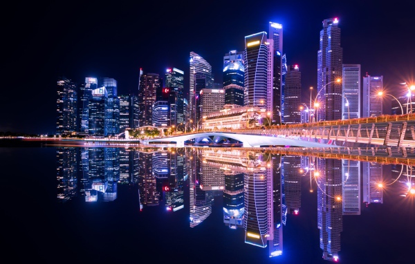 Night skyscrapers are reflected in the water, the city of Singapore, Asia