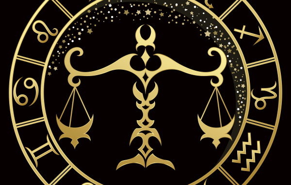 Золотой знак зодиака весы на черном фоне