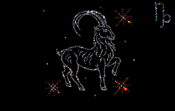 Блестящий знак зодиака козерог  на черном фоне
