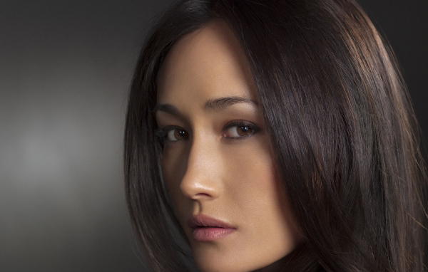 Актриса Мэгги Кью лицо крупным планом на сером фоне