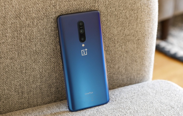 Синий смартфон ONEPLUS 7 на диване