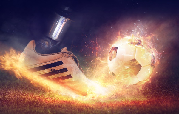 Foot beats off a fiery soccer ball