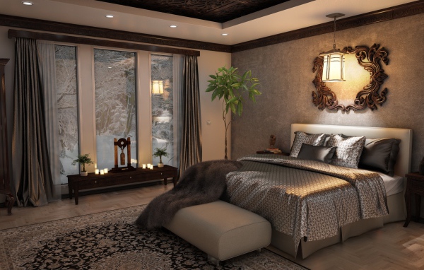 Большая кровать с красивым покрывалом в спальне с большим окном 