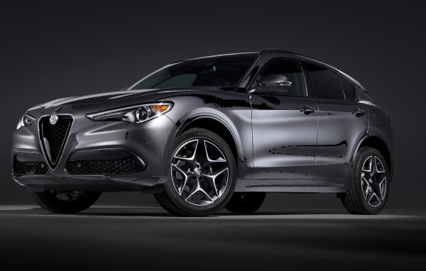 Серебристый автомобиль Alfa Romeo, 2020 года на сером фоне