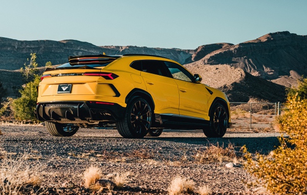 2019 yellow Lamborghini Urus car in the mountains