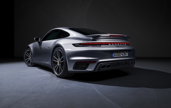 Серебристый автомобиль Porsche 911 Turbo S 2020 года вид сзади