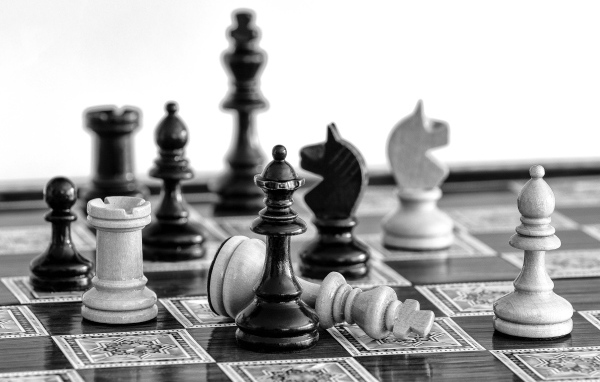 Черные и белые шахматные фигуры на доске 