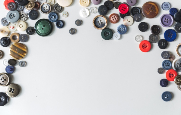 Разные пуговицы на сером фоне