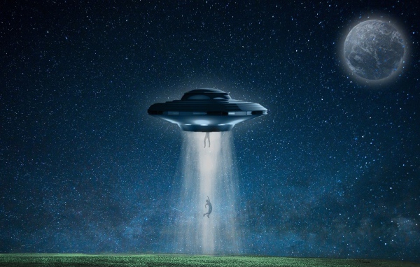 A flying saucer abducts a person at night over a field