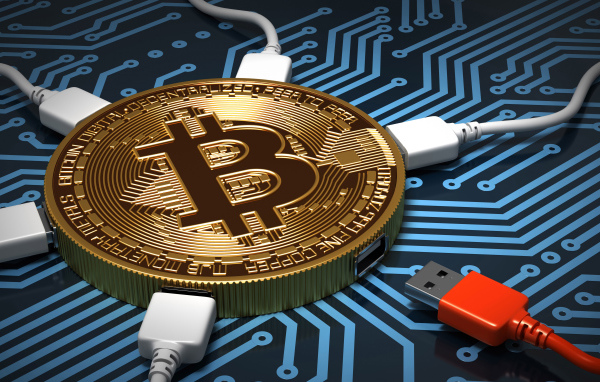 USB cable connected to bitcoin coin