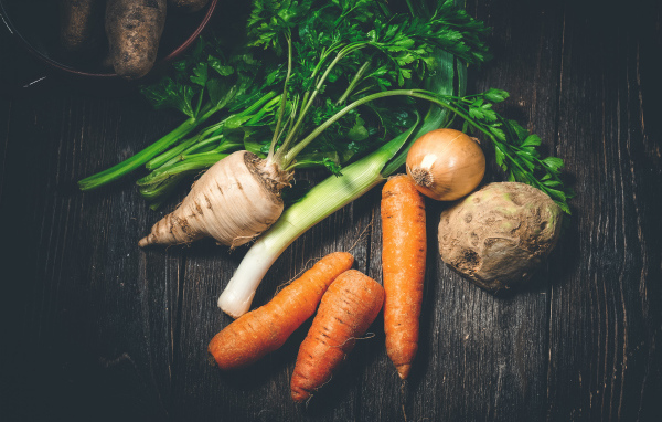 Сельдерей, морковь и лук на столе 