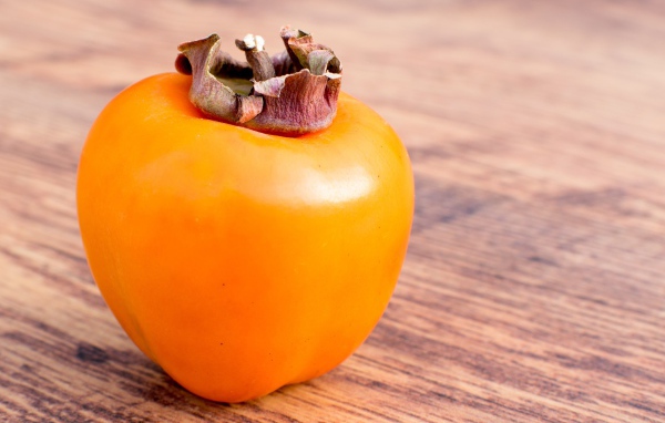 Спелая сочная хурма на столе 