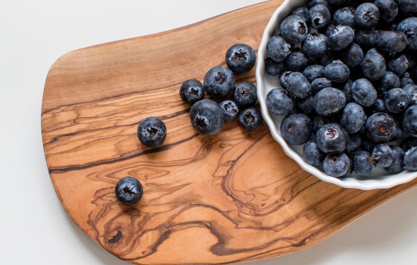 Ripe large blueberries on the board