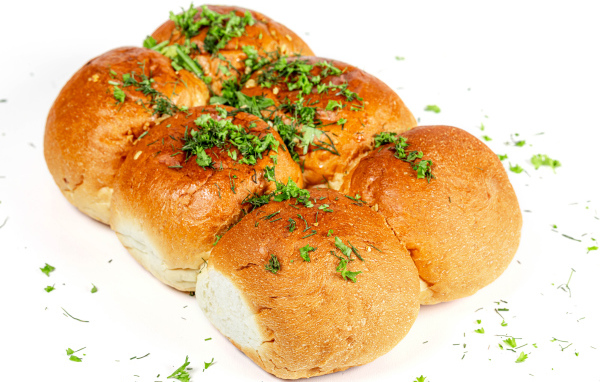 Garlic buns with herbs on a white background