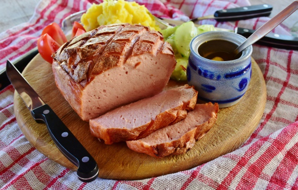 Мясной хлеб на тарелке с пюре и овощами