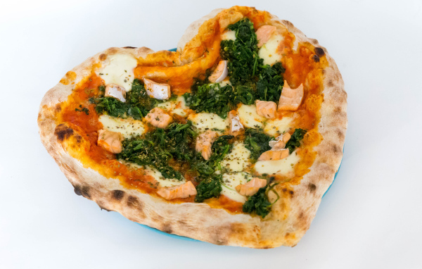 Heart shaped pizza with fish and cheese on a white background