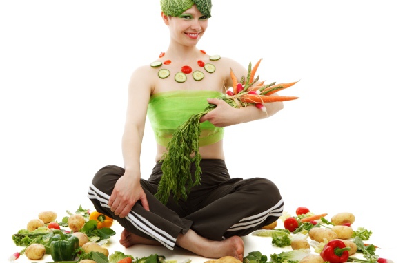 Девушка вегетарианка с овощами на белом фоне