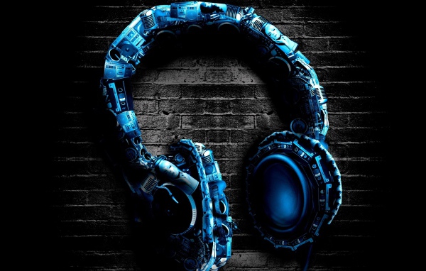 Blue stylish headphones on brick background