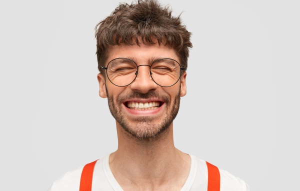 Улыбающийся бородатый мужчина в очках 