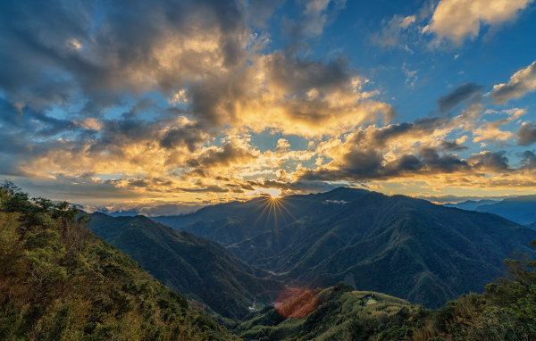 Рассвет солнца в облачном небе над горами 