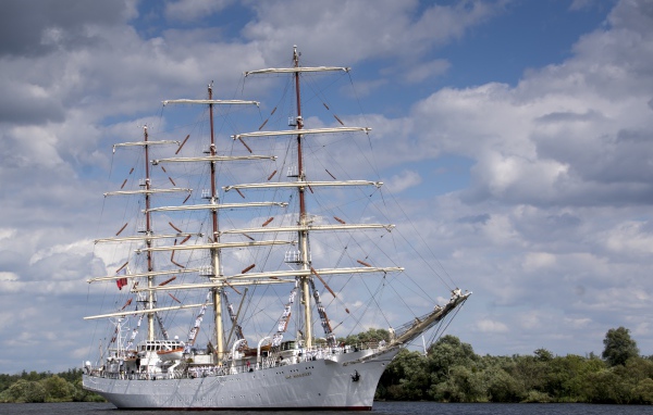 Large white ship with lowered sails