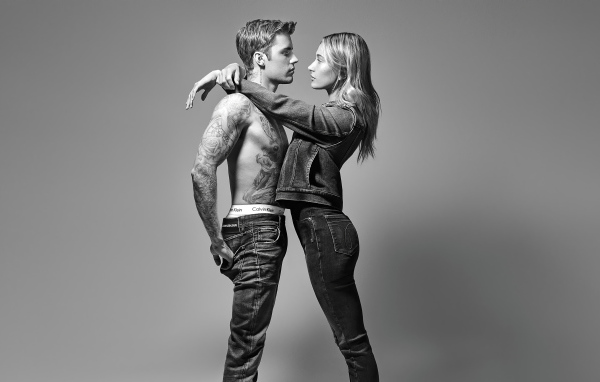 Model Hayley Baldwin and singer Justin Bieber on a gray background