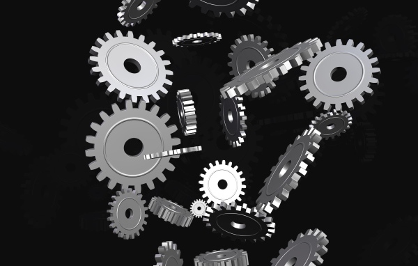 Металлические шестеренки в воздухе на черном фоне