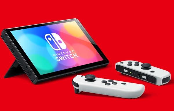 Nintendo Switch OLED game console on red background