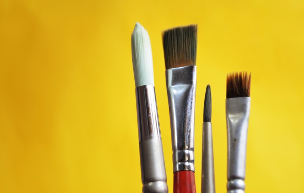 Кисти разной величины на желтом фоне
