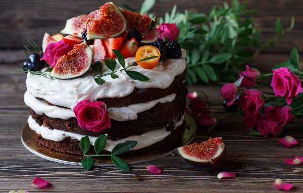 Торт с шоколадными коржами и сливочным кремом украшен ягодами