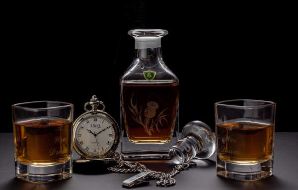 Дорогой коньяк на столе с карманными часами 
