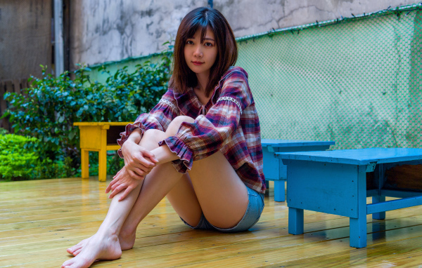 Красивая девушка азиатка в рубашке на полу 