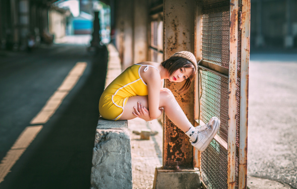 Молодая девушка азиатка сидит у сетки