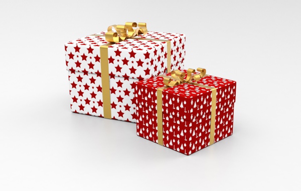 Две яркие коробки с подарками на сером фоне