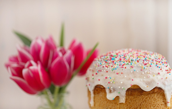 Пасхальный кулич с белой глазурью с букетом тюльпанов