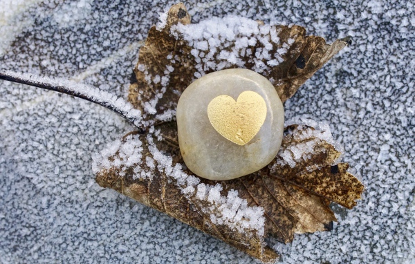 Heart in stone on snowy ground