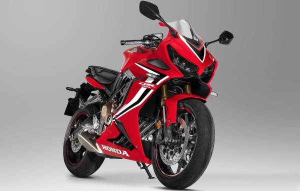 Красный мотоцикл Honda CBR 650 RR, 2021 года на сером фоне