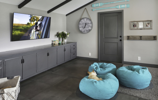 Голубые кресла в комнате с большим телевизором 