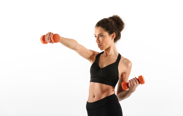 Girl shakes hands with dumbbells on a white background