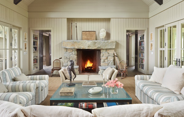 Большая гостиная комната с мягкой мебелью и камином