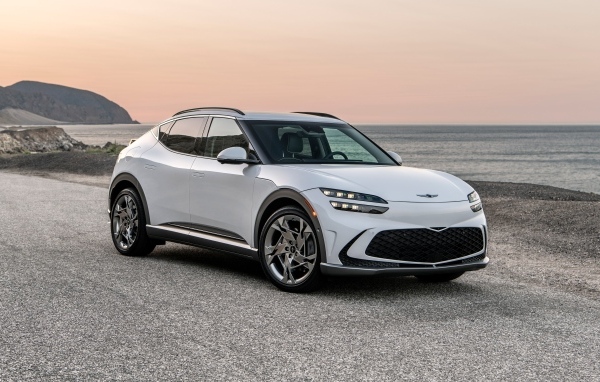 Белый автомобиль Genesis GV60, 2023 года на пляже
