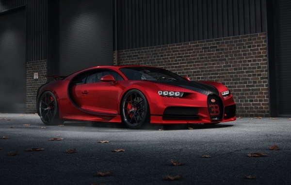 Красный автомобиль Bugatti Chiron CGI у кирпичной стены