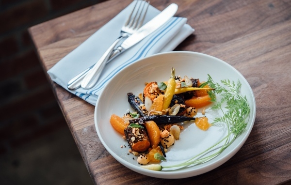 Жареные овощи на тарелке со столовыми приборами